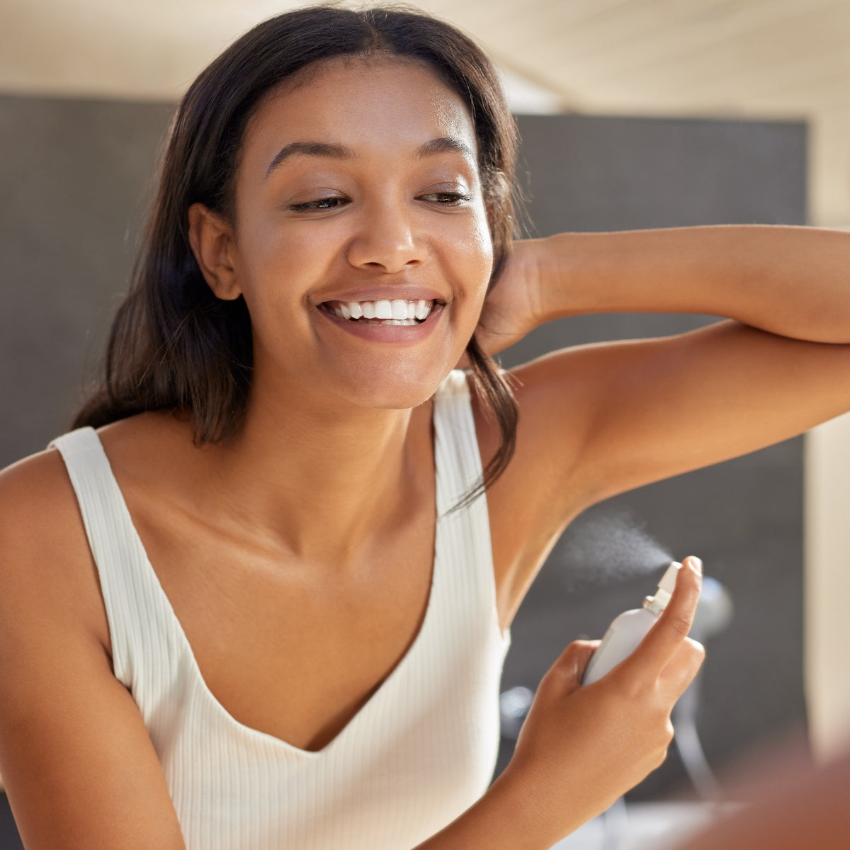 Beautiful girl using A.M.B.O. body spray