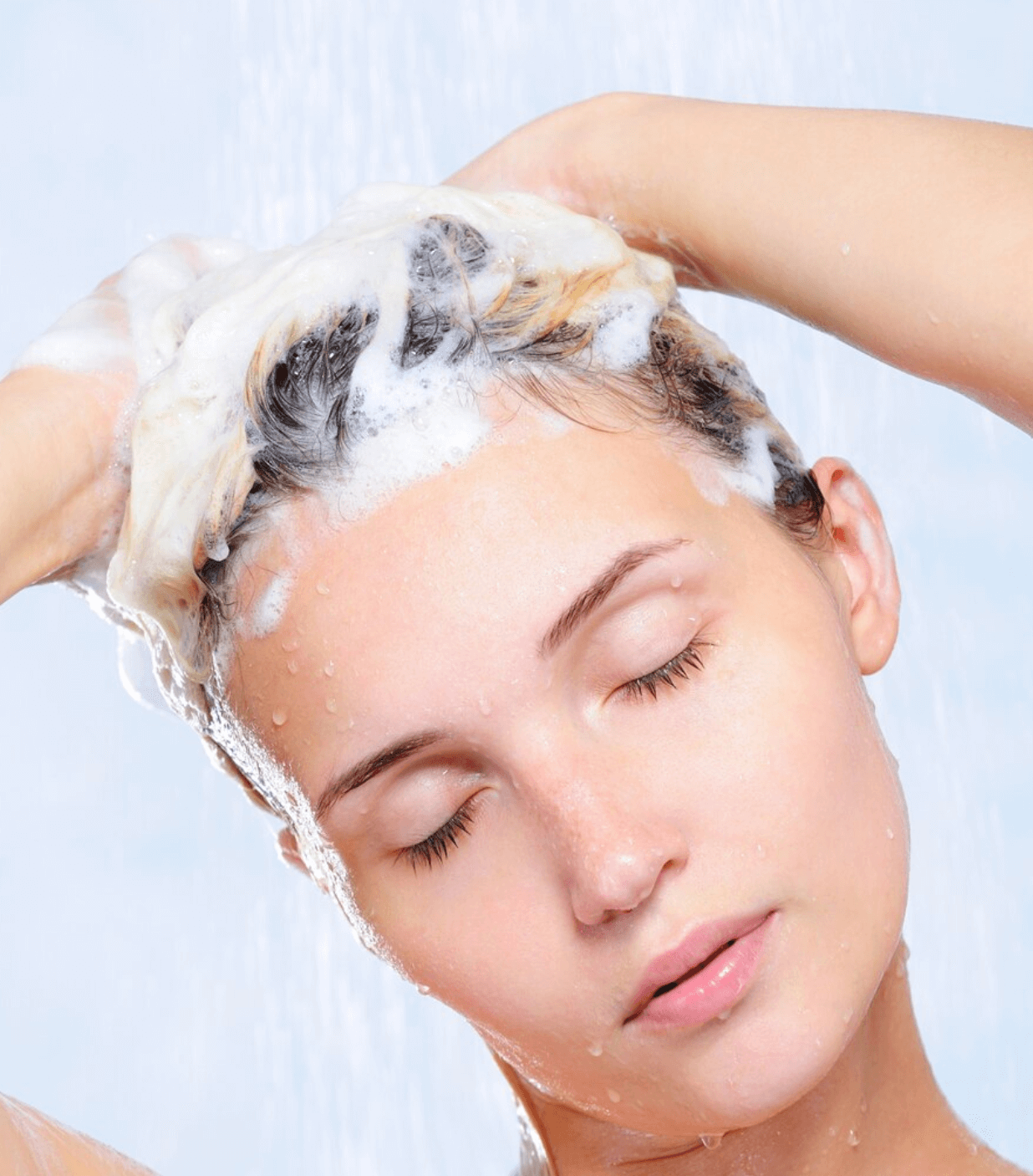 young woman shampooing hair